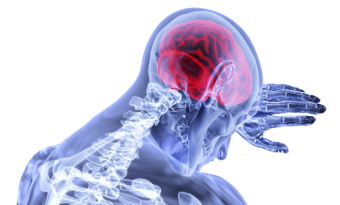 A blue x-ray style image of a person from the shoulders up. They are resting their head on their arm, and their brain is highlighted in red.